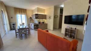 a living room with a couch and a table and a television at Il Rifugio dell'Orso in Castel di Sangro
