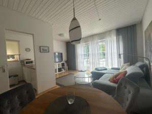 a living room with a couch and a table at Haus Seeblick Apartments mit PKW-Stellplatz am Haus in Überlingen