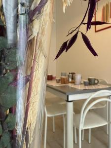a table and a chair and a table with a flower at SOLEeSALE in Pescara