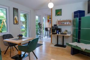 a living room with a table and a green refrigerator at Gästehaus Eisenerz in Eisenerz