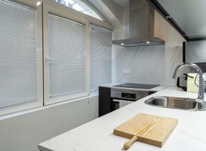 a kitchen with a wooden cutting board on a counter at Tu casa en Madrid in Madrid +22 photos