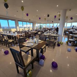 a dining room with tables and chairs and balloons at Zielo Hotel in Asuncion