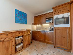 uma cozinha com armários de madeira e uma pia em Appartement chaleureux 4 pièces, 6 pers, terrasse sud, Méribel - FR-1-411-975 em Les Allues