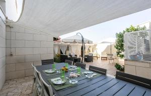 a dining table and chairs on a patio at Lovely Home In Punta Braccetto in Punta Braccetto