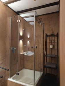 a bathroom with a shower and a sink at Konsdreffermillen B&B in Müllerthal +14 photos