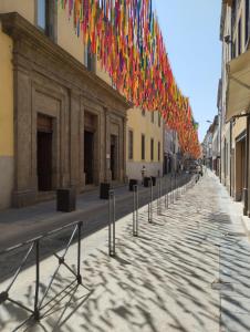 a row of flags hanging over a street at T2 Design Centre Cité 10 min in Carcassonne