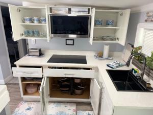 a kitchen with a desk with a computer and a sink at Cocoa, Beach house-2 in Cocoa +15 photos