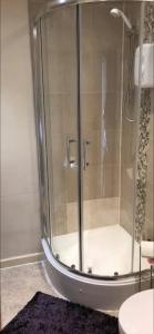 a shower with a glass door in a bathroom at 284 - Room 4 - Beachfront in Swansea