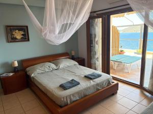 a bedroom with a bed with two towels on it at Casa Sabine in Masouri