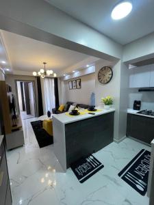 a kitchen and living room with a couch and a table at Kindaruma Homes B1402 in Nairobi +16 photos