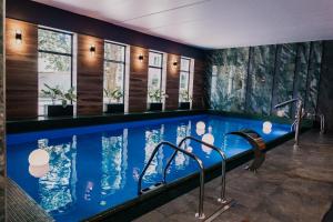 a pool in a hotel room with a swimming pool at Polanka Conference Center in Krosno