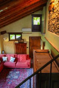 a living room with a red couch in a house at La casa Arancione in Boves