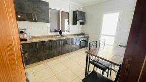 a kitchen with a table and a counter top at شقة عائلية in Nador