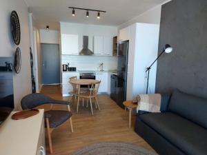 a living room and kitchen with a couch and a table at 210 The Meadows in George