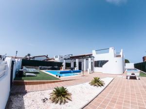 a villa with a swimming pool and a house at Villa Romans in Caleta De Fuste