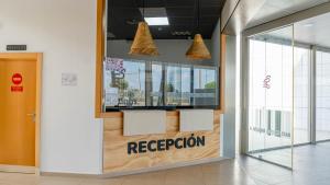 a reception area in a building with a reception sign at Albergue Las Salinas in San Pedro del Pinatar +67 photos