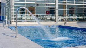 a fountain in a swimming pool in a building at Albergue Las Salinas in San Pedro del Pinatar