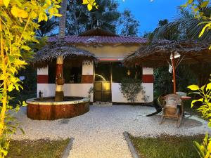 a house with a fountain in front of it at Lake Homes in Varkala