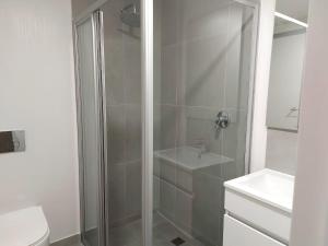 a bathroom with a shower with a toilet and a sink at 211 The Meadows in George