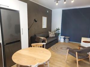 a living room with a table and a couch at 211 The Meadows in George +7 photos