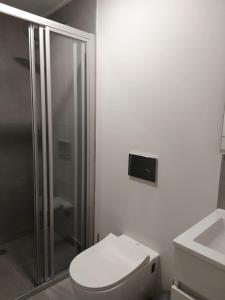 a bathroom with a toilet and a glass shower at 211 The Meadows in George