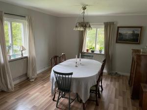 a dining room with a white table and chairs at House in Linköping in Linghem