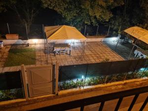 a tent and a picnic table in a park at night at La Terrazza sul Velino in Le Marmore