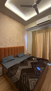 a bedroom with a large bed with a brown headboard at Sky heaven Bnb in Greater Noida