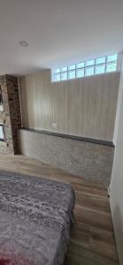 Un dormitorio con una cama y una ventana grande. en El rincon, en Cambados