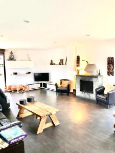 a living room with a table and a fireplace at Ak-55 Rural House in Villaviciosa