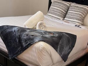 a bed with a black animal head blanket on it at Huckleberry's Hideaway in Boise