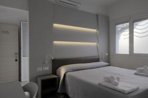 Postel nebo postele na pokoji v ubytování Hotel Maxim