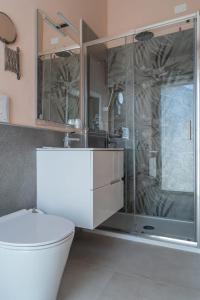 a bathroom with a toilet and a glass shower at La casa di AnNa in Cervesina