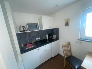 a small kitchen with a sink and a microwave at Bottermaat in Krefeld