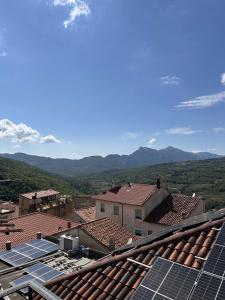 a group of roofs with solar panels and mountains at Affitti brevi FESAGI in Laurino