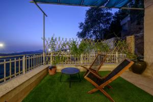 patio con sedia e tavolo sull'erba di Hostal Nazarí a Cogollos De La Vega