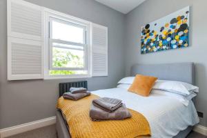 a bedroom with a bed with two towels on it at Serenity By The Sea - Broadstairs in Kent