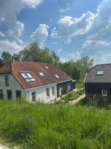 a house with a roof with solar panels on it at Het Spoel in Kuilenburg