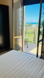a bedroom with a bed and a view of the ocean at Alba sul mare in Marina di Montenero