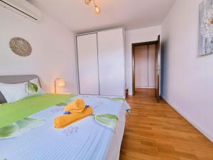 a bedroom with a bed with towels on it at Bucharest Central DD Apartment in Bucharest