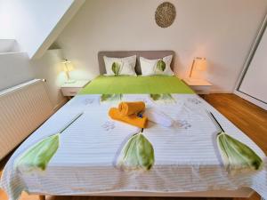 a bedroom with a bed with two towels on it at Bucharest Central DD Apartment in Bucharest