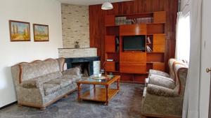 a living room with two couches and a fireplace at Refugio Andino in San Juan