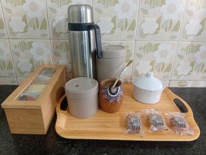 a tray with a coffee maker and cups on a counter at Refugio Andino in San Juan