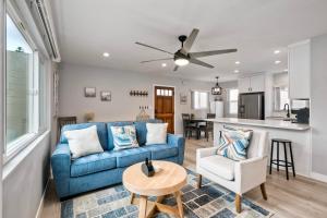 a living room with a blue couch and a table at Seabreeze 1BR, Walk to Sand, Pet Friendly, Parking, Fire Pit Access in Carlsbad