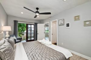 a bedroom with a bed and a ceiling fan at Seabreeze 1BR, Walk to Sand, Pet Friendly, Parking, Fire Pit Access in Carlsbad