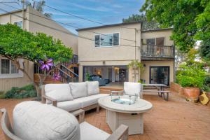 a patio with a couch and chairs and a table at Seabreeze 1BR, Walk to Sand, Pet Friendly, Parking, Fire Pit Access in Carlsbad