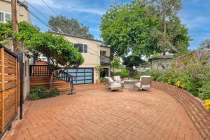 a patio with chairs and a table and a house at Seabreeze 1BR, Walk to Sand, Pet Friendly, Parking, Fire Pit Access in Carlsbad +7 photos