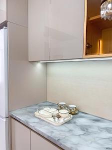 a kitchen counter with two plates and bowls on it at ЖК Millennium in Bishkek +37 photos