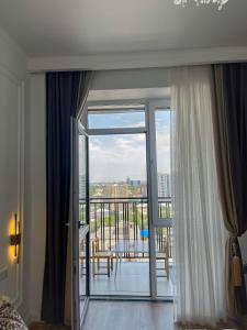 a room with a sliding glass door with a balcony at ЖК Millennium in Bishkek