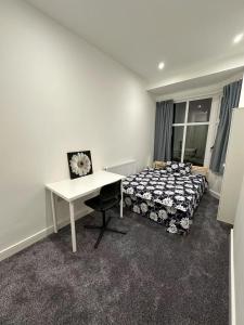 a bedroom with a bed and a desk and a table at City Stays at St Patricks - Private Ensuites in Coventry